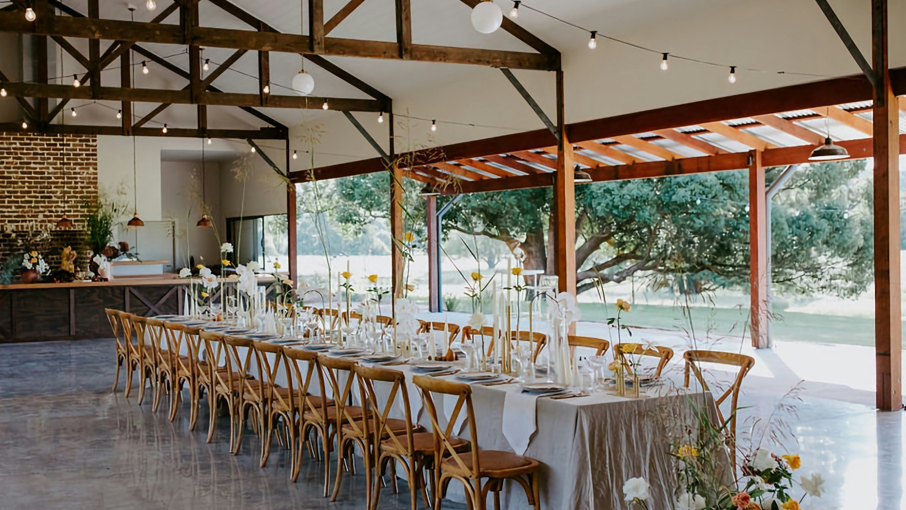 Outlook from a timber barn. Tables setup for a wedding reception.